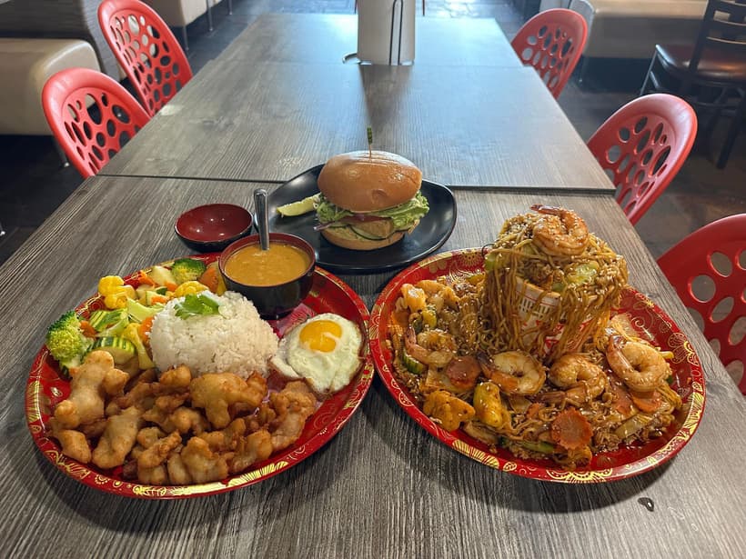 Bangkok Grill table spread with noodles, rice, and curry