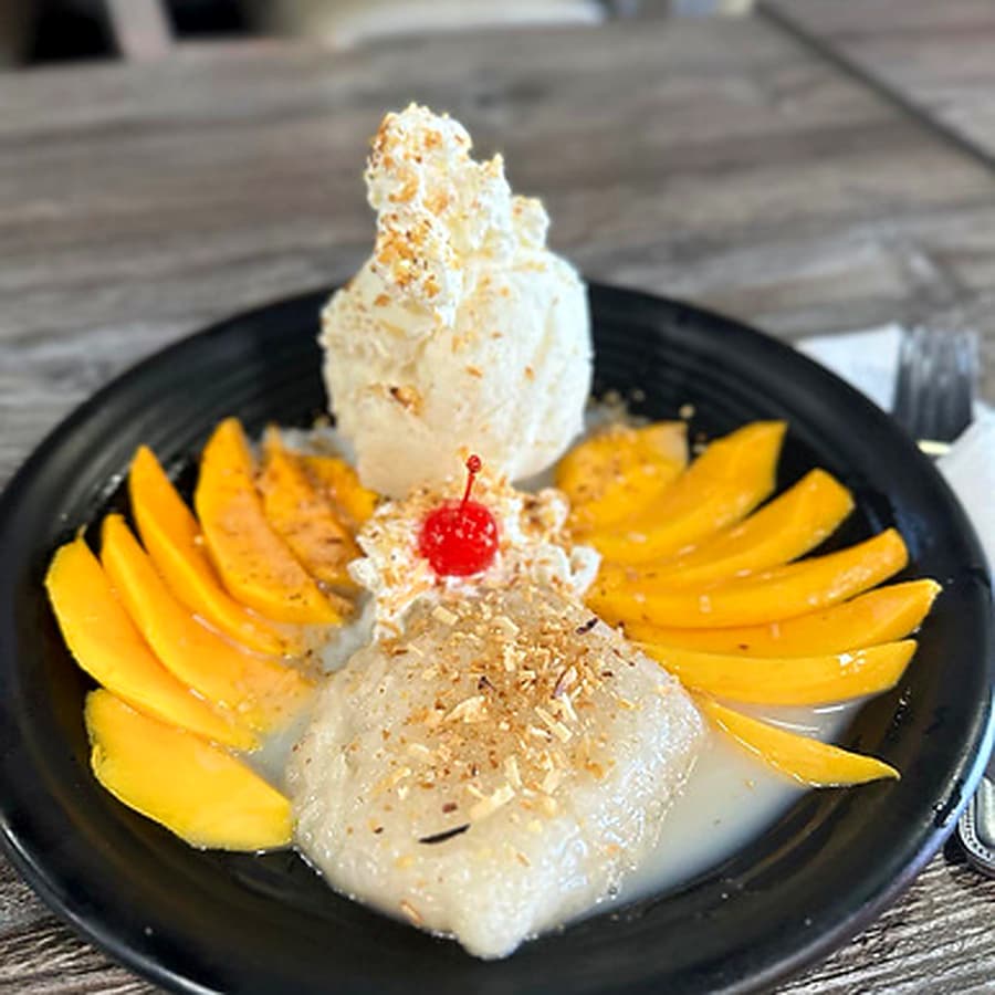 Mango sticky rice dessert on a white plate